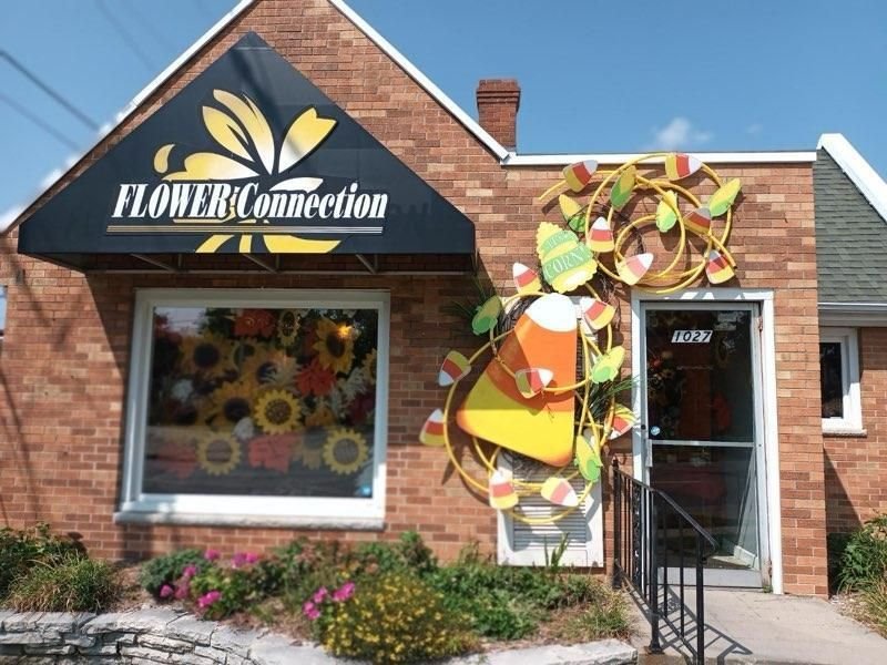 The Flower Connection storefront with a giant candy corn